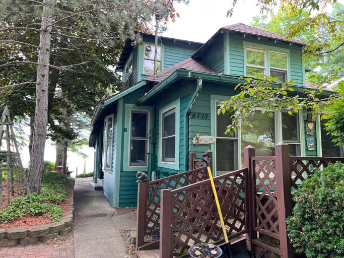 Green House Exterior With Trees And Pathway