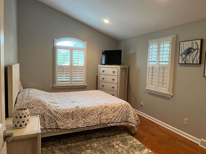 Interior Bedroom With Bed, Dresser, And Windows