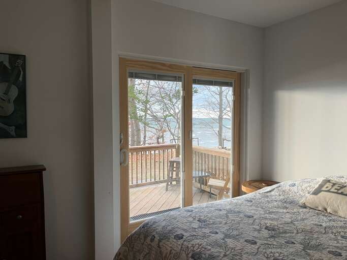 First floor primary bedroom with full bath and Lake views