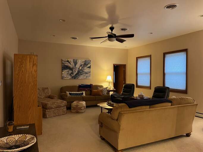 Spacious Living Area With Sofas, Subtle Lighting, And Serene Decor In A Vacation Rental