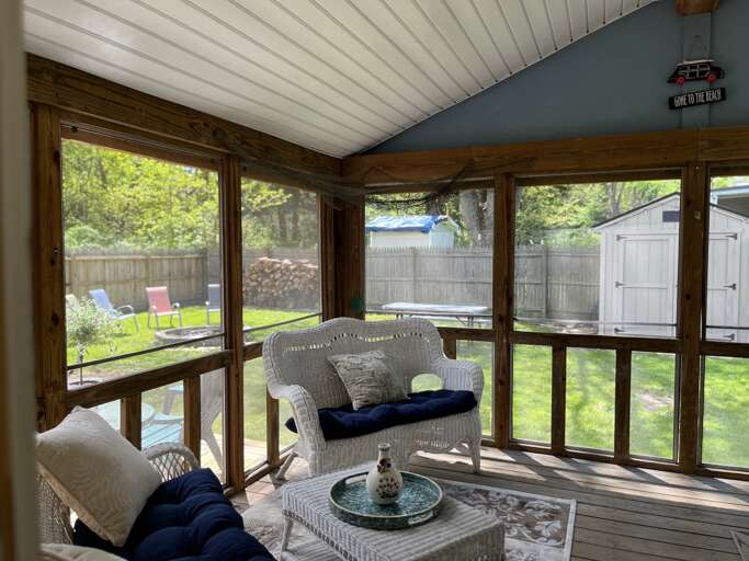 Sunlit Screened Space Showcasing Simple Seating And Scenic Garden Glimpse